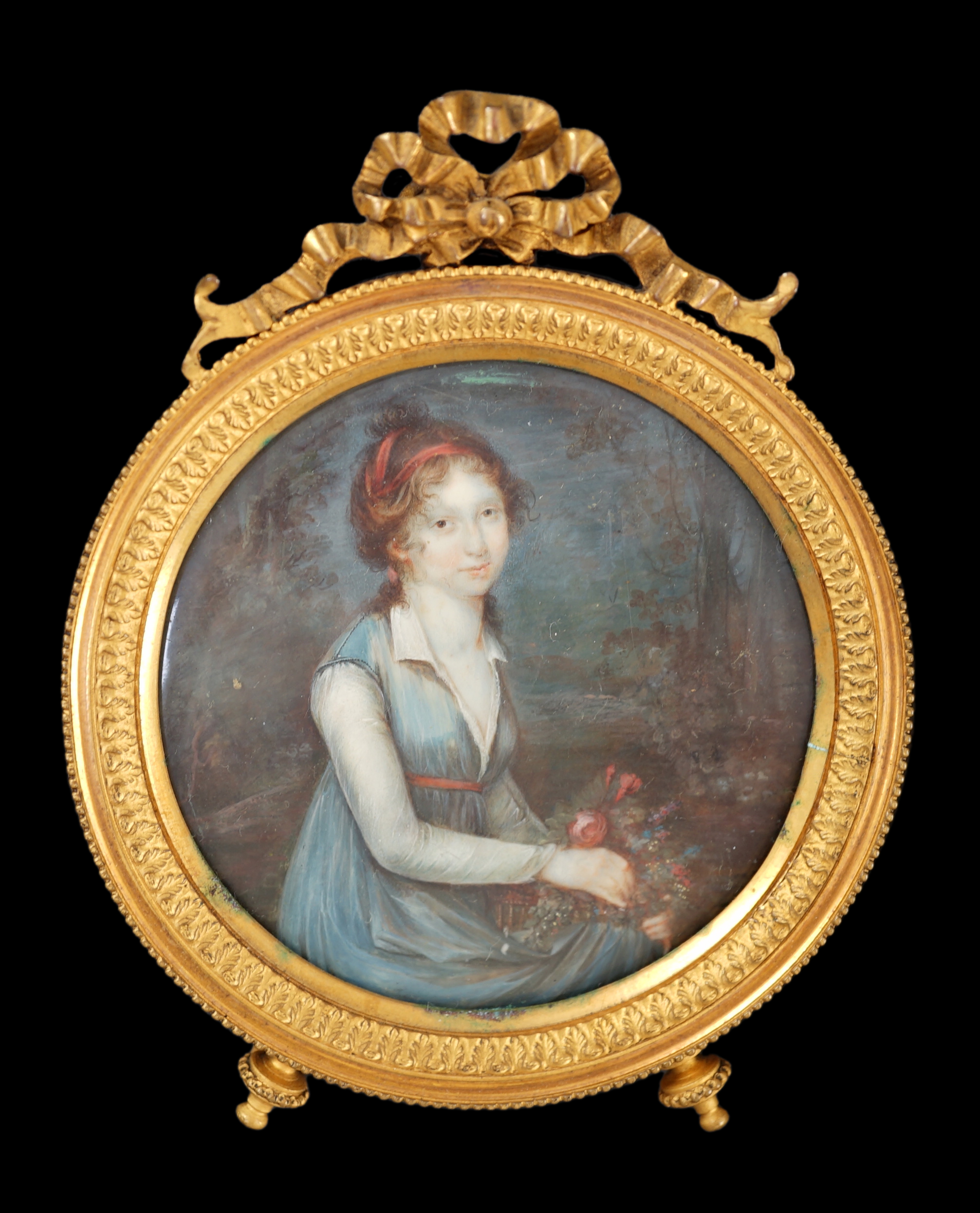 French School circa 1870, Portrait miniature of a lady seated in parkland, watercolour on ivory, tondo, 6.8cm. CITES Submission reference 8CHHM4M3